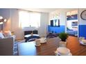 Modern dining area with wood table and blue accent chairs at 215 Piedmont Ne Ave # 1905, Atlanta, GA 30308