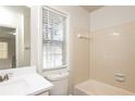 Clean bathroom with beige tile, white vanity, and bathtub at 894 Churchill Ct, Stone Mountain, GA 30083