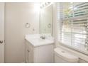Simple bathroom with white vanity and a window at 894 Churchill Ct, Stone Mountain, GA 30083