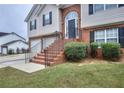 House's front entrance with brick steps and landscaping at 8432 Browns Mill Trce, Stonecrest, GA 30038