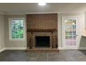 Living room with a brick fireplace and access to a deck at 2852 Caraway Dr, Tucker, GA 30084