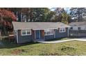 Newly renovated one-story home with gray siding and a landscaped lawn at 26 Reeves St, Norcross, GA 30071