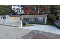Charming gray house with a white picket fence and newly paved driveway at 26 Reeves St, Norcross, GA 30071