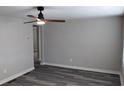Bright living room with gray walls, wood-look floors, and ceiling fan at 26 Reeves St, Norcross, GA 30071