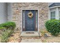 Elegant front door with stone surround and seasonal wreath at 3579 Oakshire Se Way, Atlanta, GA 30354