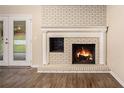 Living room fireplace with brick surround and wood mantel at 3661 Collins Dr, Douglasville, GA 30135