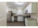 Renovated kitchen featuring white cabinets and granite countertops at 6677 Songwood Dr, Austell, GA 30168