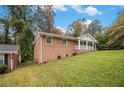 Side view of brick ranch house with a large yard at 796 Vanderbilt Nw Ct, Atlanta, GA 30318