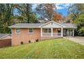 Brick ranch house with a covered porch and landscaped yard at 796 Vanderbilt Nw Ct, Atlanta, GA 30318