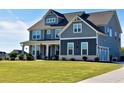 Two story home with gray siding, white trim, and a large front yard at 100 Leveret Rd, Locust Grove, GA 30248