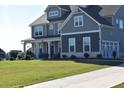 Gray siding two story home with a large grassy yard and driveway at 100 Leveret Rd, Locust Grove, GA 30248
