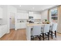 Modern kitchen featuring white cabinets, granite countertops, and a large island at 4175 Viola Pl, Atlanta, GA 30349