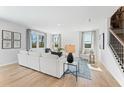Spacious living room with hardwood floors, large windows, and a comfortable sectional sofa at 4175 Viola Pl, Atlanta, GA 30349