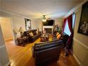 Living room featuring hardwood floors, fireplace and ample seating at 4761 Habersham Way, Conyers, GA 30094