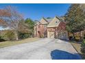 Two-story home with a three-car garage and a large driveway at 3423 Mulberry Lane Ct, Dacula, GA 30019