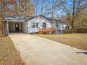 House exterior showcasing a carport and driveway at 2870 Aunt Pitty Pat Ln, Douglasville, GA 30135