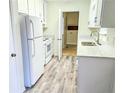 Renovated kitchen with white cabinets and quartz countertops at 2870 Aunt Pitty Pat Ln, Douglasville, GA 30135