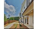 Townhome community with walkway, landscaping, and wooden fence at 2108 Irvin Ct, Kennesaw, GA 30144