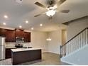 Open-concept kitchen and dining area with dark wood cabinets, stainless steel appliances, and a large island at 2108 Irvin Ct, Kennesaw, GA 30144