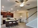 Modern kitchen with dark wood cabinets, stainless steel appliances, and an island with bar seating at 2108 Irvin Ct, Kennesaw, GA 30144