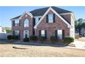 Attractive two-story brick home with black shutters and a landscaped front yard at 6476 Snowden Dr, Atlanta, GA 30349