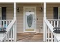 Front door entrance with a white door and decorative glass at 201 Nina Cir, Locust Grove, GA 30248