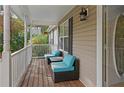 Porch with teal wicker seating and a wooden floor at 201 Nina Cir, Locust Grove, GA 30248
