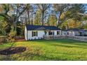 Ranch home with a fenced yard, mature trees, and a spacious lawn at 2804 Sanford Se Rd, Smyrna, GA 30080