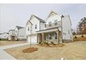 Two-story home with brick and white siding, a covered porch, and a two-car garage at 3952 Adler Cir, Buford, GA 30519