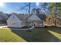 Gray siding and brick accents characterize this charming craftsman home at 312 Brook Hollow Ln, Loganville, GA 30052