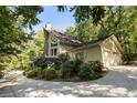 A two-story home with attached two car garage, nestled in a private wooded setting at 123 Cherry St, Roswell, GA 30075