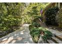Brick and stone walkway leading to home with mature trees surrounding property at 123 Cherry St, Roswell, GA 30075
