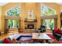 Spacious living room with hardwood floors, stone fireplace, and abundant natural light at 123 Cherry St, Roswell, GA 30075