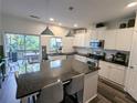 Modern kitchen with granite island, stainless steel appliances, and white cabinets at 1317 Liberty Nw Pkwy, Atlanta, GA 30318