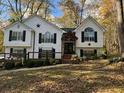 Two-story home with white exterior, black shutters, and a covered porch at 5673 Yorktown Rd, Douglasville, GA 30135