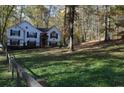 Spacious backyard with wooden fence and mature trees at 5673 Yorktown Rd, Douglasville, GA 30135