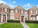 Attractive brick townhome with a 2-story design and manicured lawn at 7512 Rutgers Cir, Fairburn, GA 30213