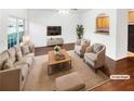 Virtually staged living room featuring hardwood floors, neutral decor, and ample natural light at 7512 Rutgers Cir, Fairburn, GA 30213