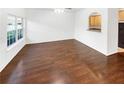 Spacious living room with hardwood floors and a neutral color palette at 7512 Rutgers Cir, Fairburn, GA 30213