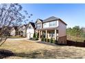 Two-story house with brick and siding, two-car garage, and landscaped yard at 6280 Stillwood Ln, Cumming, GA 30041