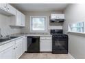 Modern kitchen with white cabinets, black appliances, and granite countertops at 2196 Swallow Se Cir, Atlanta, GA 30315