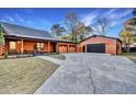 Log cabin home with a spacious driveway and detached garage at 923 Pine Cir, Woodstock, GA 30189