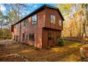 Side view of the house showcasing its wood siding and landscaping at 4771 Cool Springs Rd, Winston, GA 30187