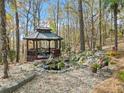 Peaceful gazebo with pond and waterfall, surrounded by autumn trees at 291 Miquel Jorge Ln, Canton, GA 30115