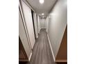 Long hallway with doors leading to various basement rooms at 6700 Roswell Rd # 13B, Atlanta, GA 30328