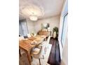 Elegant dining room featuring a rustic wood table and chandelier at 6700 Roswell Rd # 13B, Atlanta, GA 30328
