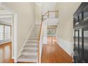 Two-story foyer with hardwood floors and a grand staircase at 727 Pear Grove Pl, Marietta, GA 30066