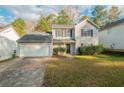 Two-story house with attached garage and lawn at 6390 Alford Cir, Lithonia, GA 30058