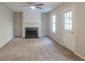 Living room with fireplace and neutral carpeting at 6390 Alford Cir, Lithonia, GA 30058