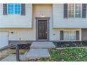 Front entrance with dark brown door and steps leading to the house at 2076 Scarbrough Dr, Stone Mountain, GA 30088